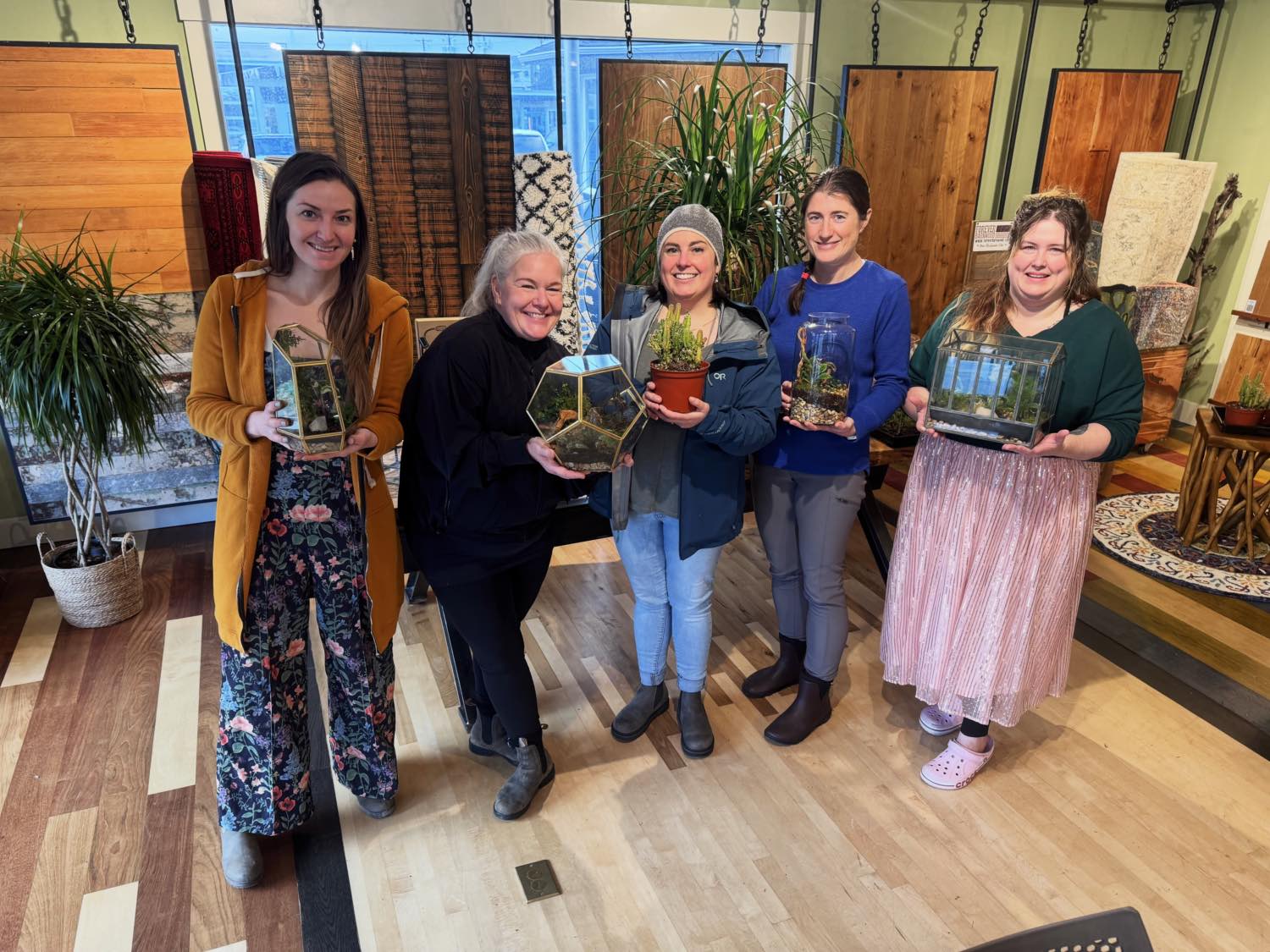 Five guests holding the terrariums they built at INSIDE