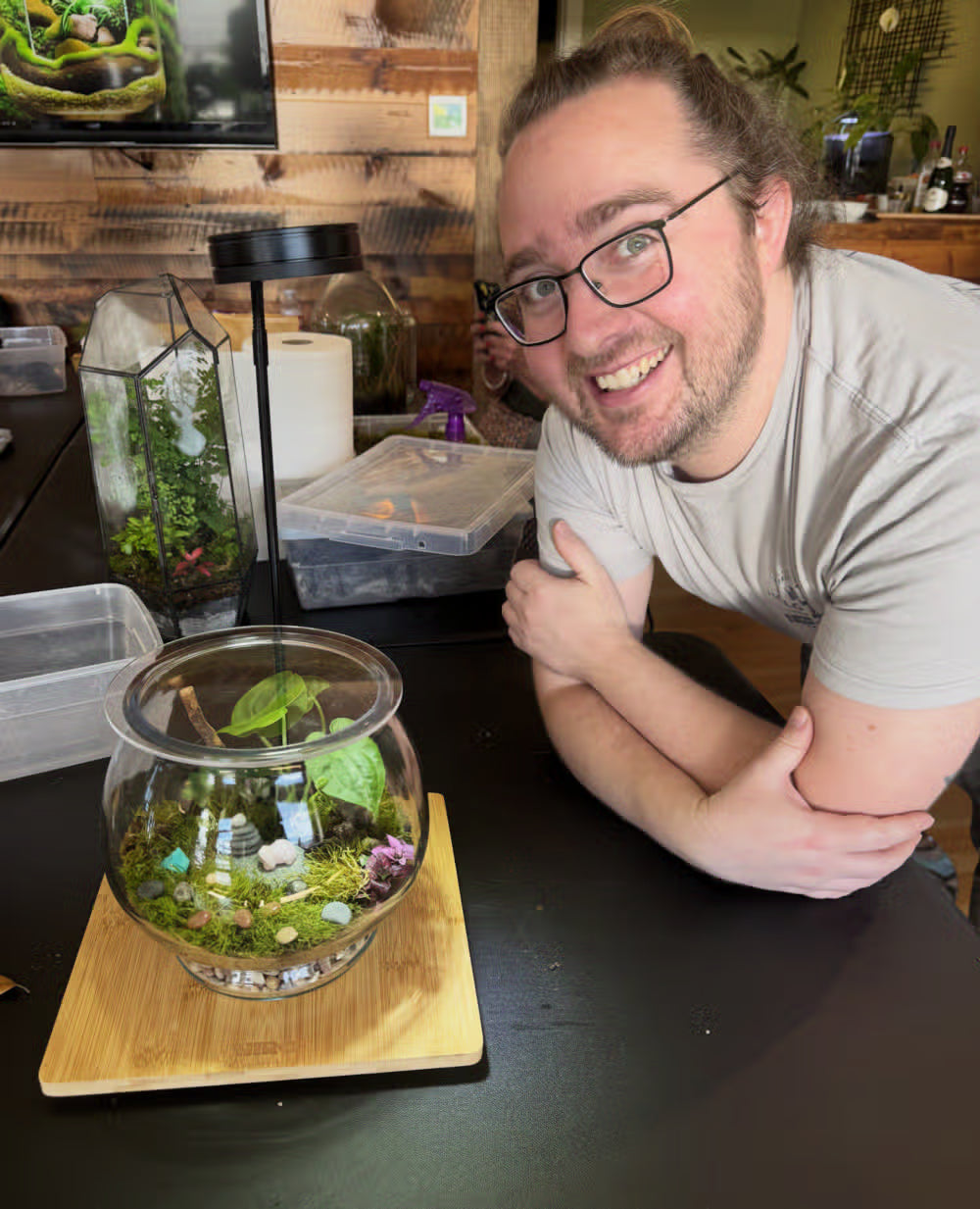 A guest focused on building his terrarium at INSIDE